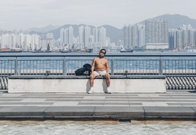 男人黑背心坐在替补席上具体的白天
